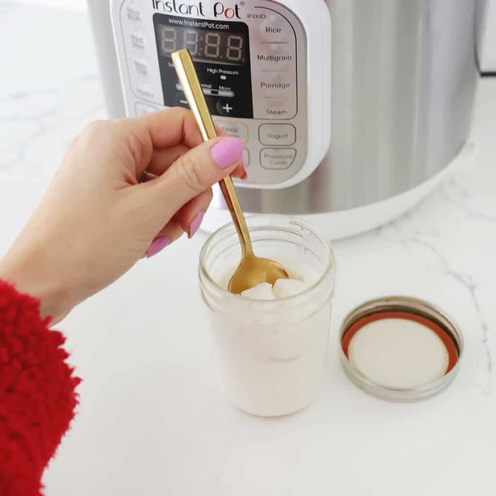 yogurt in glass jar by an instant pot